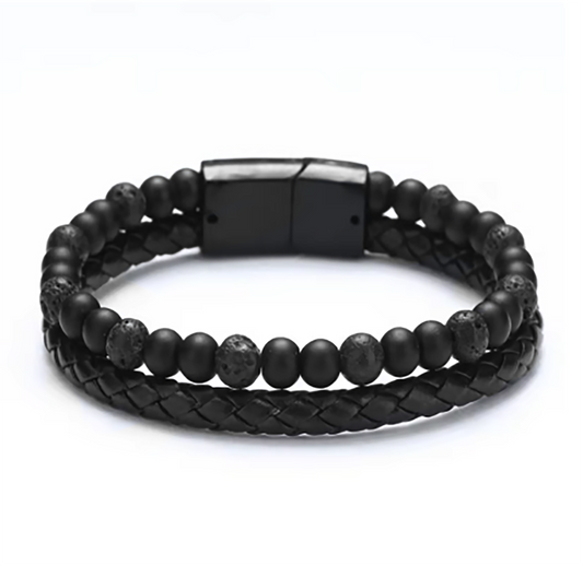 The Men’s Leather and Beaded Bracelet with Stainless Steel Clasp by FR | Art Jewellery (Thamus Design) features a braided leather band, round black and brown gemstone beads, and a sleek stainless steel clasp.
