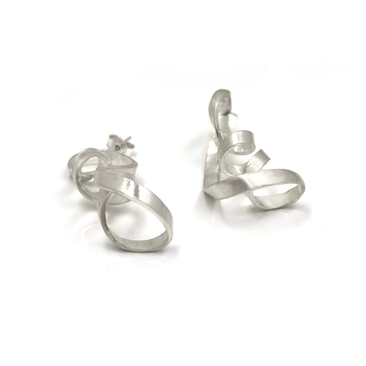 Introducing the Archi Long Sterling Silver Earrings by FR | Art Jewellery. These handmade earrings feature a twisted looping design with smooth, flowing curves in a chic silver-tone. Slightly asymmetrical, they exude artistic flair and modern appeal, making them perfect for those who appreciate unique styles.