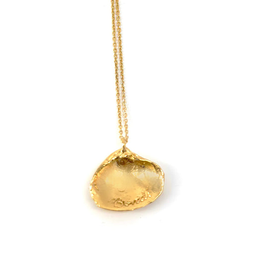 The Bondi Shell I Sterling Silver Necklace from FR | Art Jewellery features a gold clam shell-shaped pendant with a detailed, textured design that exudes a realistic allure. The thin, delicate chain accentuates the elegant craftsmanship of this exquisite piece of handmade jewelry.