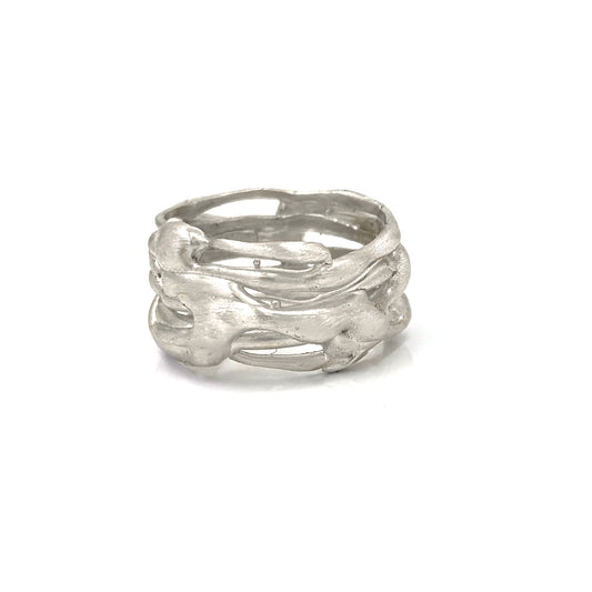 The Carousel Sterling Silver Ring by FR | Art Jewellery is showcased against a plain white backdrop, featuring an organic, intertwined design. The surface of the ring displays a natural, flowing pattern that echoes its nature-inspired origins, giving it a unique and artistic allure.