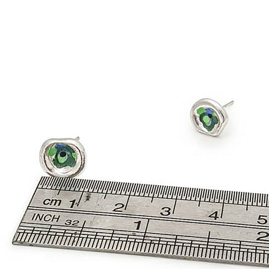 The Colour Dot Earrings Sterling Silver Forest from FR | Art Jewellery showcase two round earrings made of sterling silver, each adorned with small blue and green gemstones at their center. These earrings, known for their smooth, polished finish and contemporary design, are displayed side by side against a plain white background.