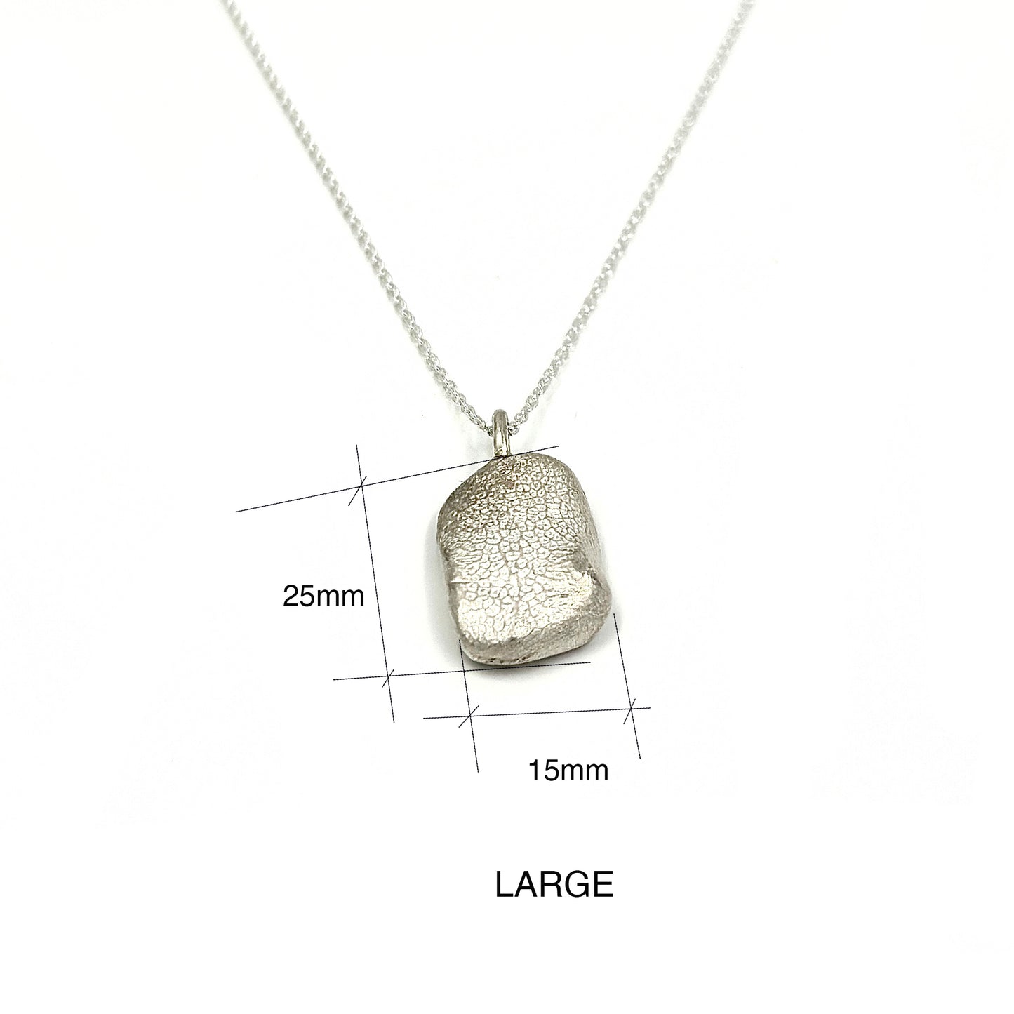 A petite, rectangular silver pendant named "Dog Imprint" by FR | Art Jewellery features a slightly irregular and textured surface. This custom keepsake pendant has a flat loop at the top for easy attachment to a chain or necklace, elegantly set against a plain white background.