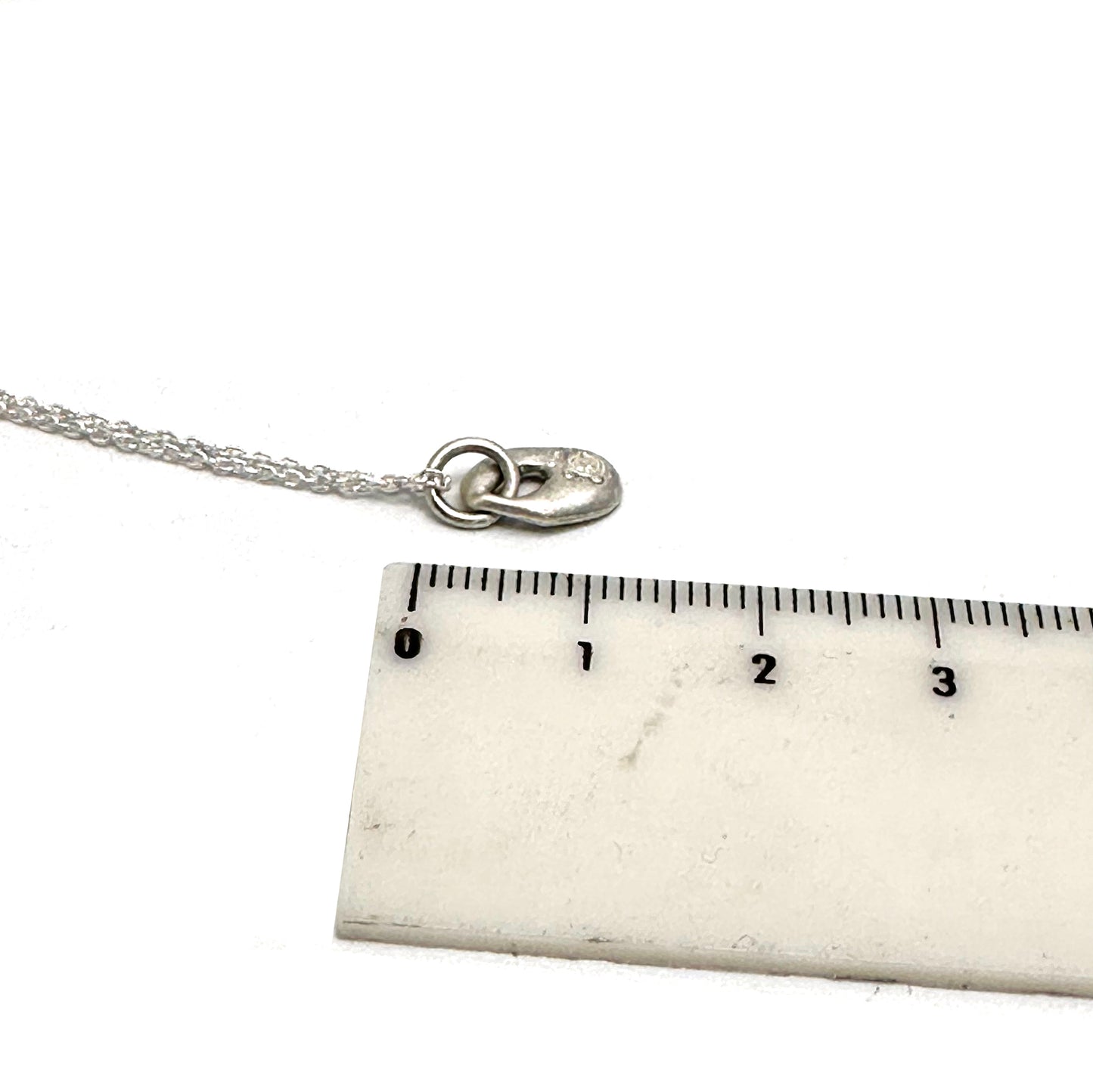 The Eye Sterling Silver Necklace by FR | Art Jewellery features a handmade sterling silver chain with a topaz accent, offering subtle elegance to any look.