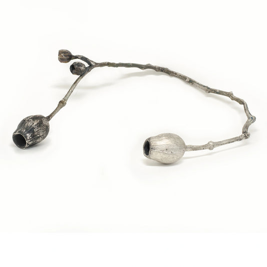The Gumtree Sterling Silver Necklace by FR | Art Jewellery is showcased with two metallic, pod-shaped forms—one darker in the foreground, one lighter further back—evoking Australian flora on a plain white background.