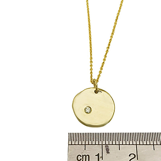 Introducing the Full Moon Sterling Silver and Gold Necklace, an exquisite piece of handmade jewelry by FR | Art Jewellery. This necklace features a round pendant with a single diamond elegantly set into its surface, gracefully hanging from a delicate gold chain against a pristine white background.