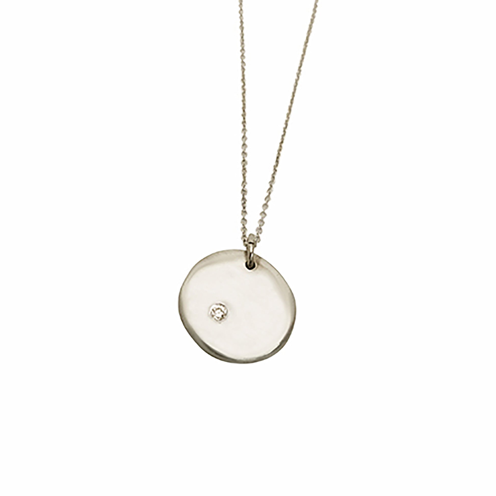 Introducing the Full Moon Sterling Silver and Gold Necklace, an exquisite piece of handmade jewelry by FR | Art Jewellery. This necklace features a round pendant with a single diamond elegantly set into its surface, gracefully hanging from a delicate gold chain against a pristine white background.