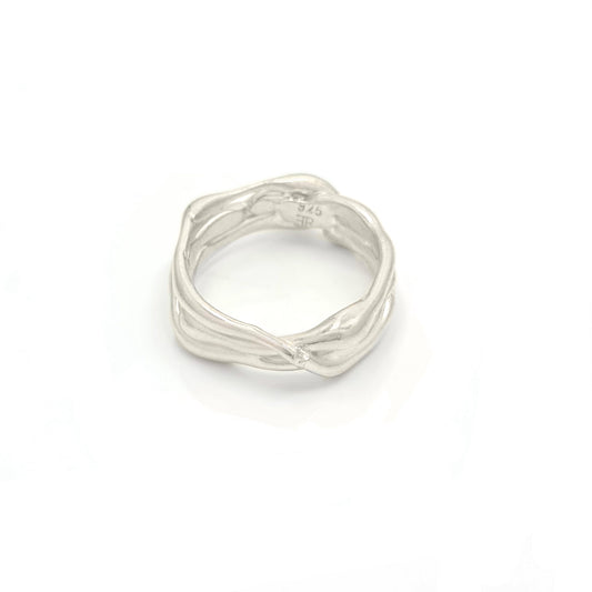 Part of the Curves Collection, the Freedom Infinite Sterling Silver Ring by FR | Art Jewellery is crafted to mimic intertwined branches, resulting in a textured and organic look. The ring stands out beautifully against a white background.