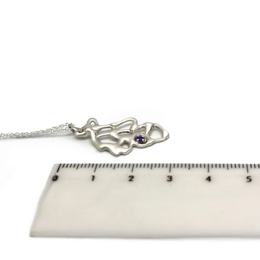 The Leaf Necklace by FR | Art Jewellery is a handmade sterling silver piece with an abstract organic pendant and a small purple gemstone, from the Blossom series, shown on a white background.