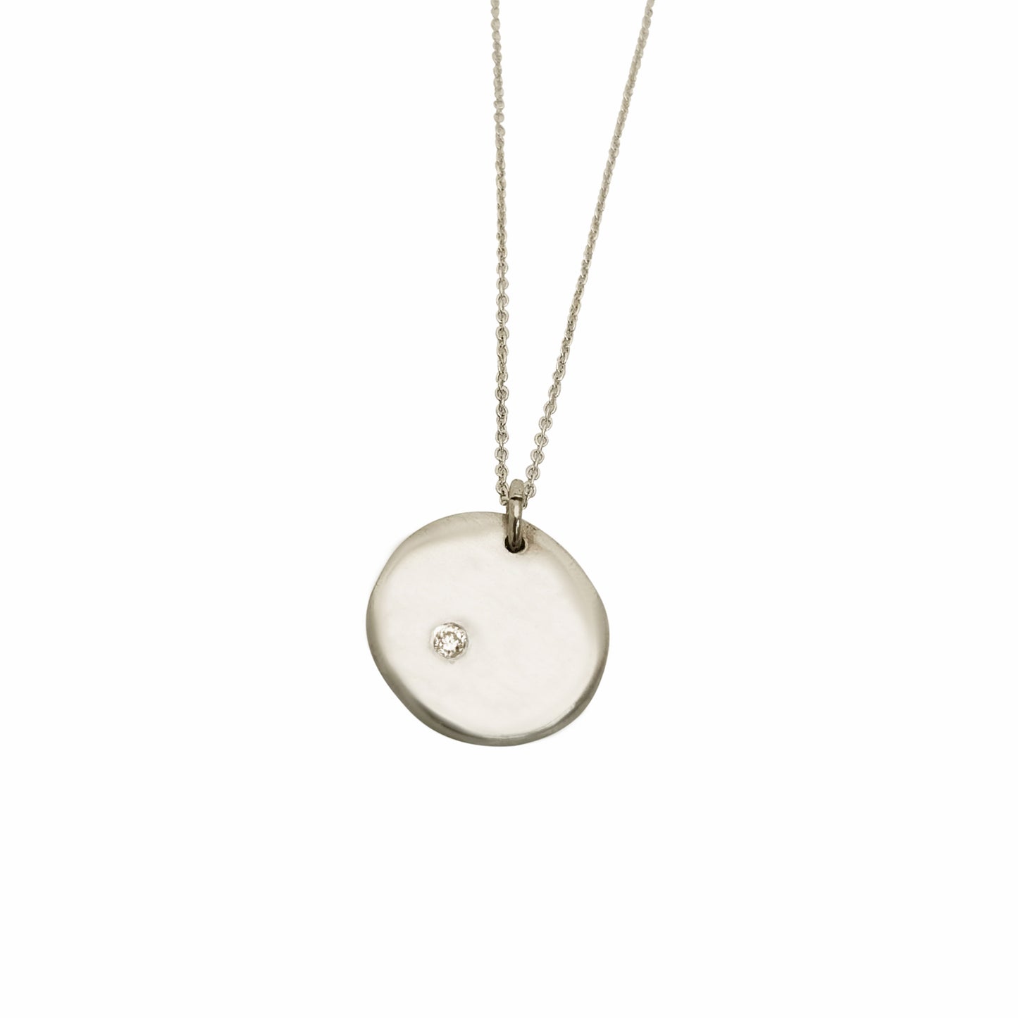Introducing the Full Moon Sterling Silver and Gold Necklace, an exquisite piece of handmade jewelry by FR | Art Jewellery. This necklace features a round pendant with a single diamond elegantly set into its surface, gracefully hanging from a delicate gold chain against a pristine white background.