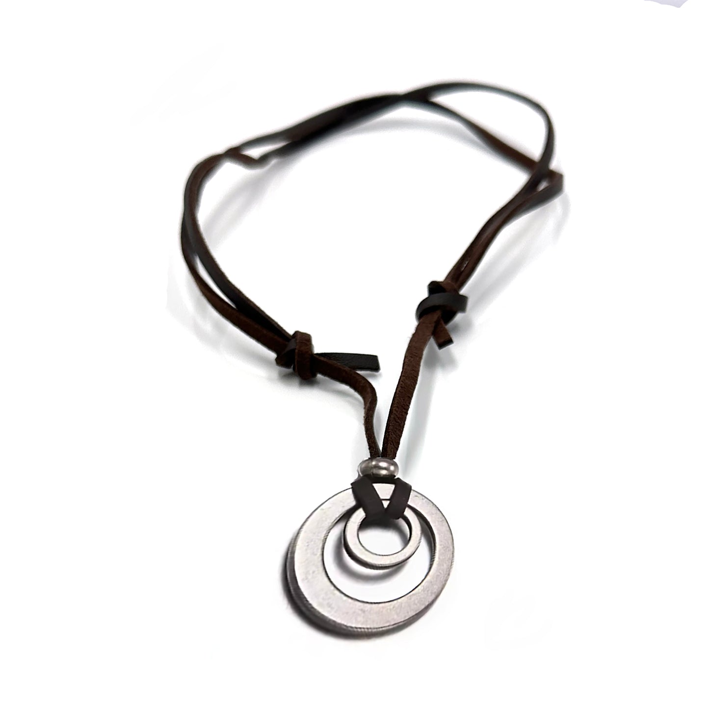 The FR | Art Jewellery Stainless Steel and Leather Circle Necklace by Thamus Design features two linked silver rings on a brown leather cord with knot and bead accents, shown against a white background.