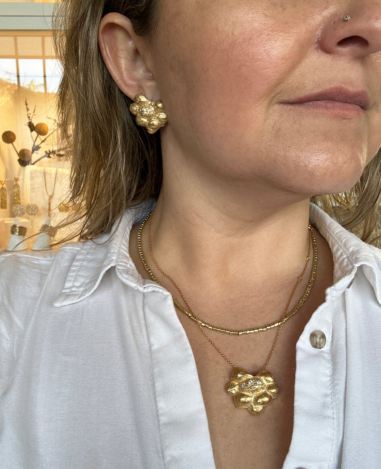 Pine Earrings gold plated in sterling silver FR Art Jewellery handmade by Francisca Rendic on a model, wearing both earrings and necklace