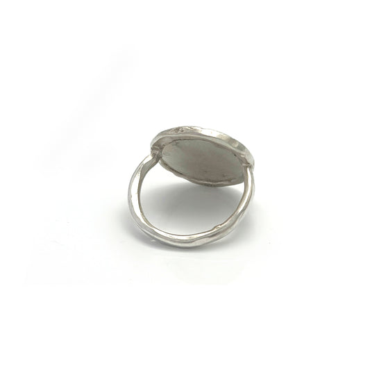 The Silver Leaf Impression Ring – Sterling Silver by FR | Art Jewellery features a wide, round flat top with subtle, nature-inspired engravings and a raised edge, beautifully showcased against a white background.
