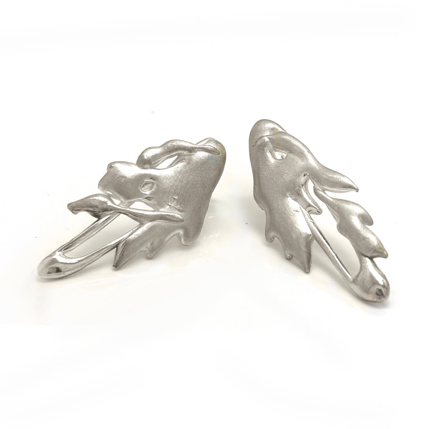 The Symbio Earrings – Gold Plated in Sterling Silver by FR | Art Jewellery feature an abstract wavy, leaf-like design and are handmade wearable art, showcased elegantly against a white background.