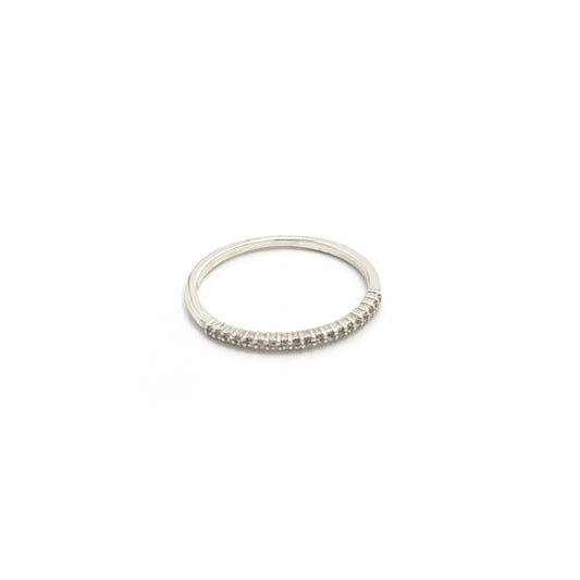 The Tiny Eter Ring (Quartz) by FR | Art Jewellery features a delicate silver pavé band with small clear stones along the top half, ideal for stacking or as elegant daily wear, shown on a white background.