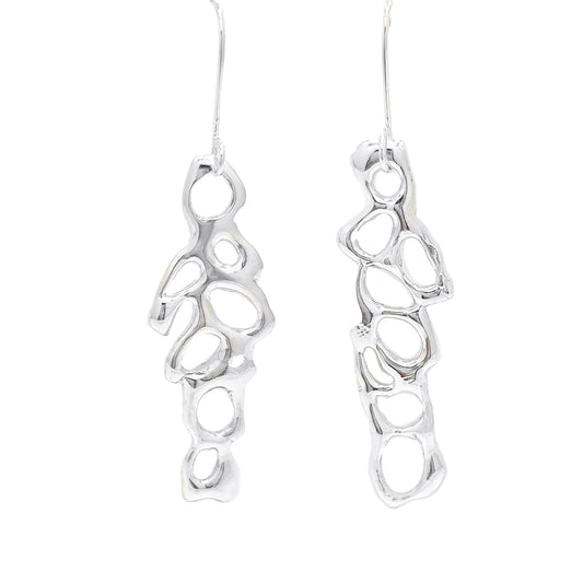 Introducing the "Angel Earrings" by FR | Art Jewellery: a stunning pair of silver earrings featuring an abstract, organic design with irregularly shaped open cutouts. This handmade jewellery piece boasts long hooks for easy insertion into pierced ears and a shiny, polished finish.