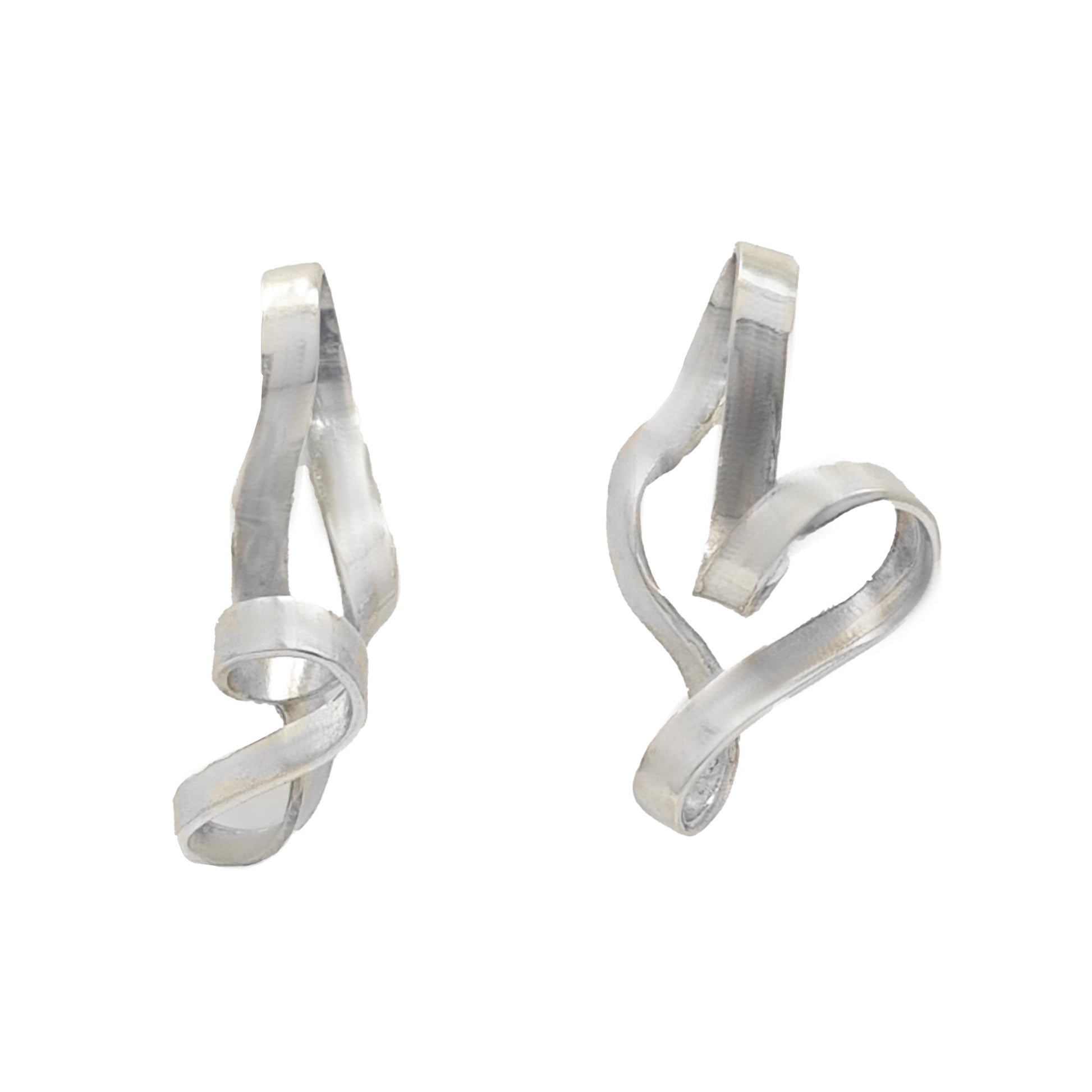 The Archi Small Earrings by FR | Art Jewellery feature two silver-colored, abstract metal pieces shaped like elegant, flowing ribbons. Each earring twists and curves, creating unique and artistic forms. The surface is smooth with a slightly reflective finish that accentuates the curves, exemplifying the beauty of handmade jewellery.