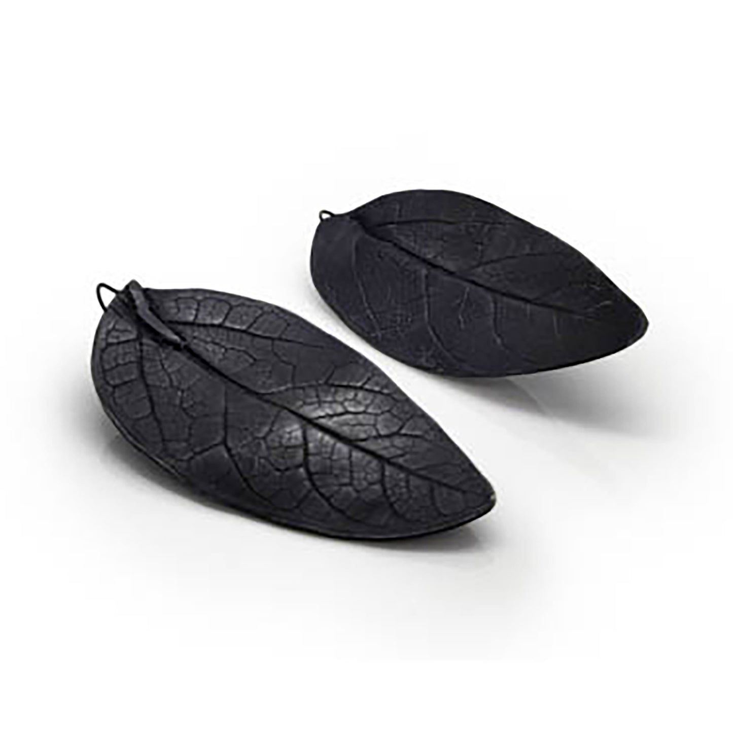 Introducing the Black Leaf Earrings by FR | Art Jewellery: a stunning pair of dark, leaf-shaped earrings featuring intricate vein patterns that mimic real leaves. Each handcrafted piece is designed for secure fastening with a hook, showcasing a unique design where the left earring has a gently curved shape and the right one remains more flat and straight.