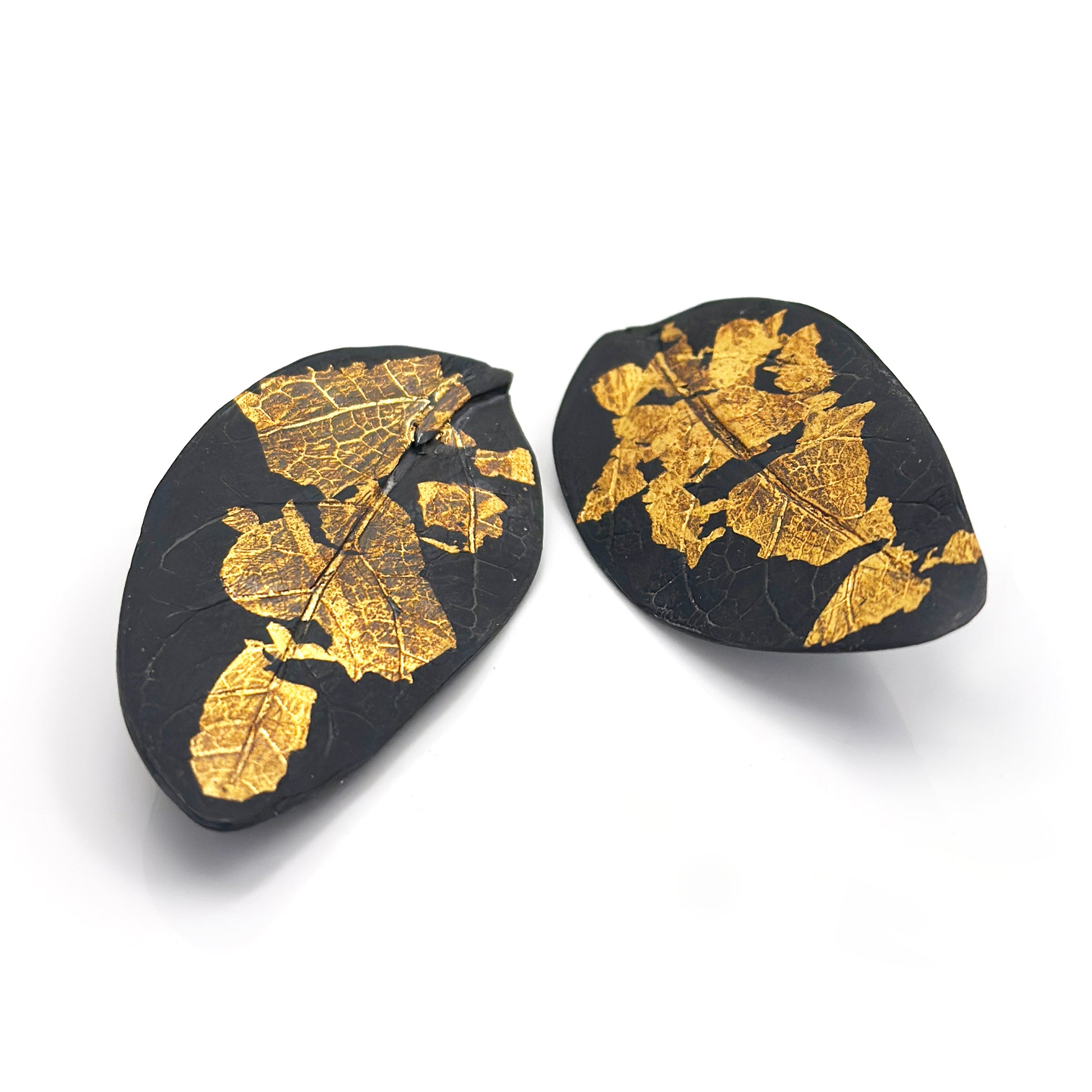 Close-up of the Black Leaf Sterling Silver Earrings by FR | Art Jewellery, showcasing the intricate veins and textures against a plain white background.