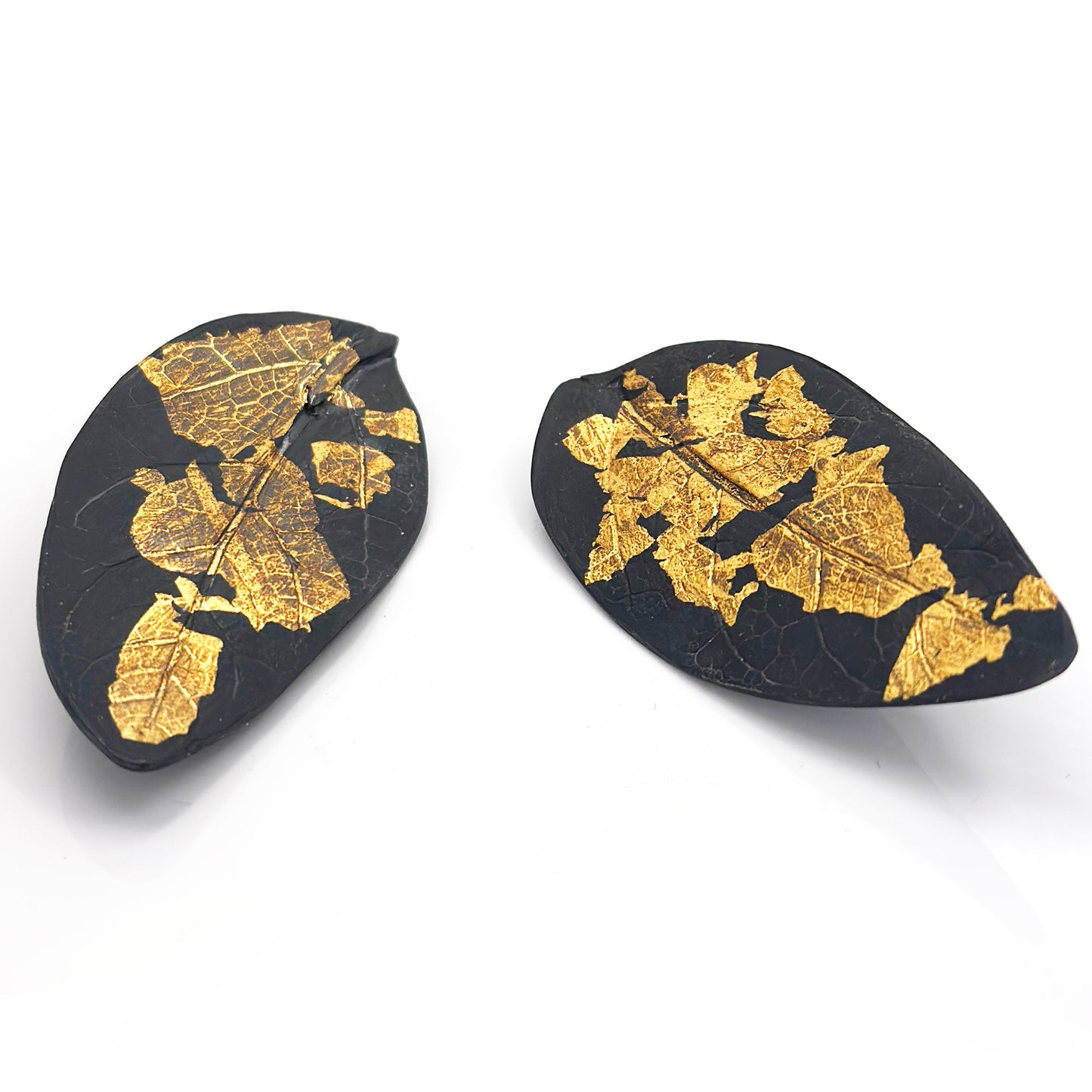 Close-up of the Black Leaf Sterling Silver Earrings by FR | Art Jewellery, showcasing the intricate veins and textures against a plain white background.