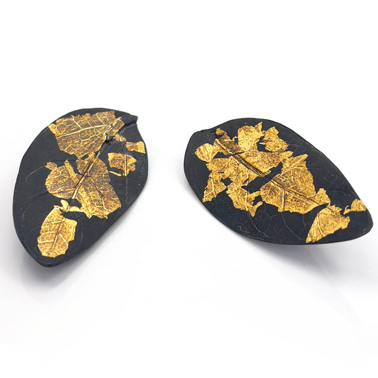 Close-up of the Black Leaf Sterling Silver Earrings by FR | Art Jewellery, showcasing the intricate veins and textures against a plain white background.