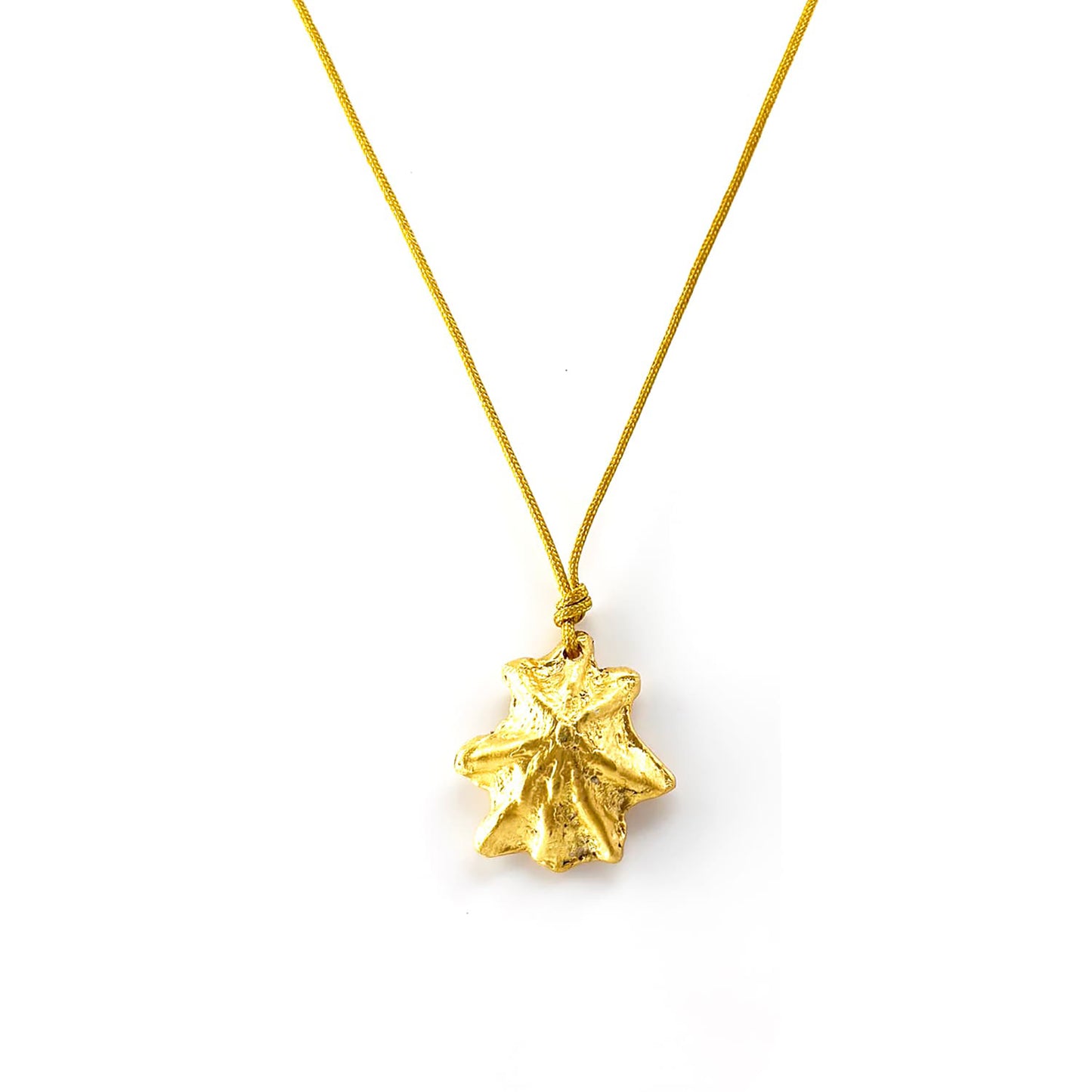 The Bronte Shell I Necklace by FR | Art Jewellery is a stunning piece featuring a gold pendant shaped like a star-shaped leaf, hanging from a delicate gold chain. This handmade jewellery shines brilliantly and is perfect for those who appreciate artisanal craftsmanship. The background is plain white.