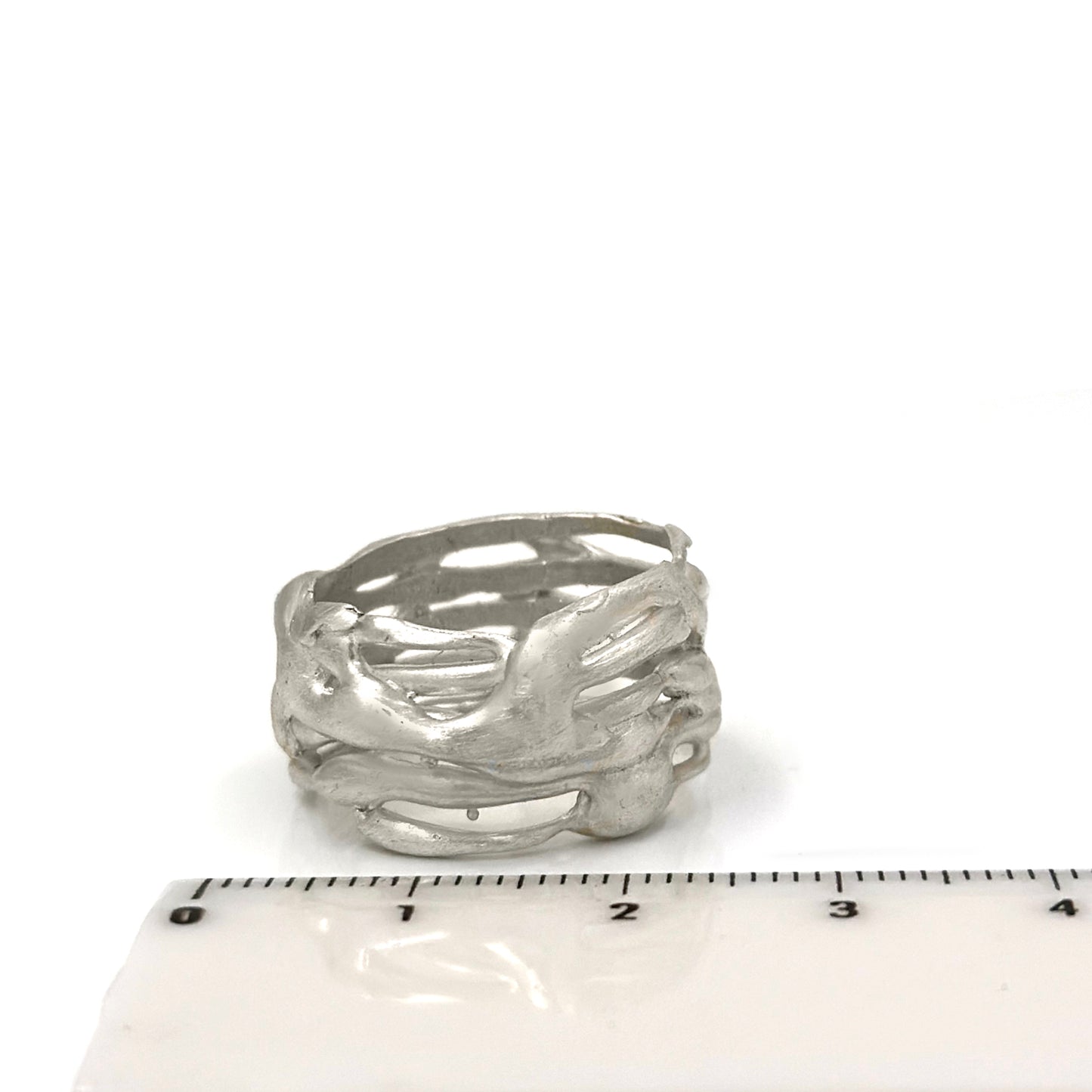 The Carousel Ring by FR | Art Jewellery features a nature-inspired textured design resembling intertwined branches, photographed on a white background. This silver ring boasts a matte finish and an organic, handcrafted appearance, perfectly capturing the essence of handmade jewellery.