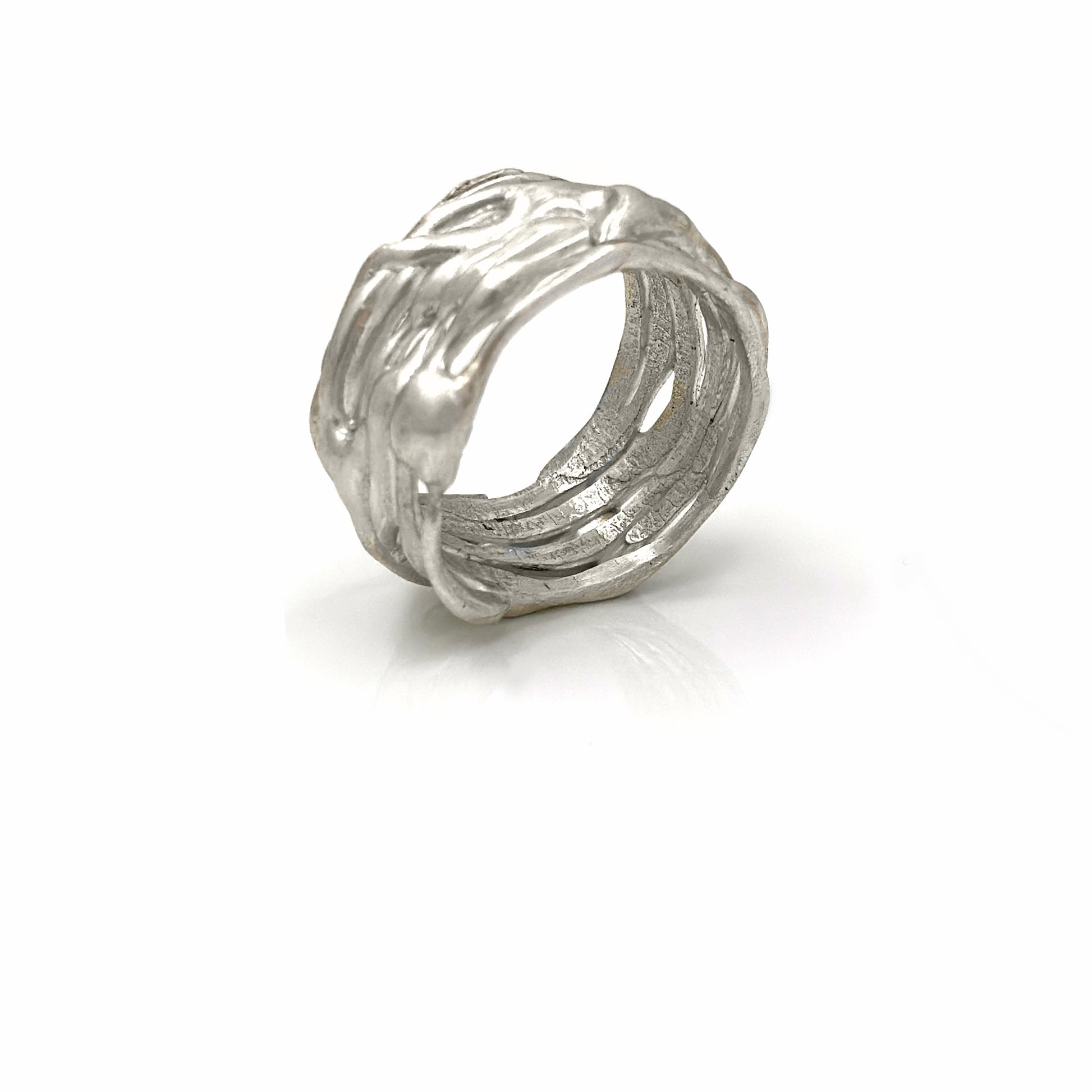 The Carousel Ring by FR | Art Jewellery features a nature-inspired textured design resembling intertwined branches, photographed on a white background. This silver ring boasts a matte finish and an organic, handcrafted appearance, perfectly capturing the essence of handmade jewellery.