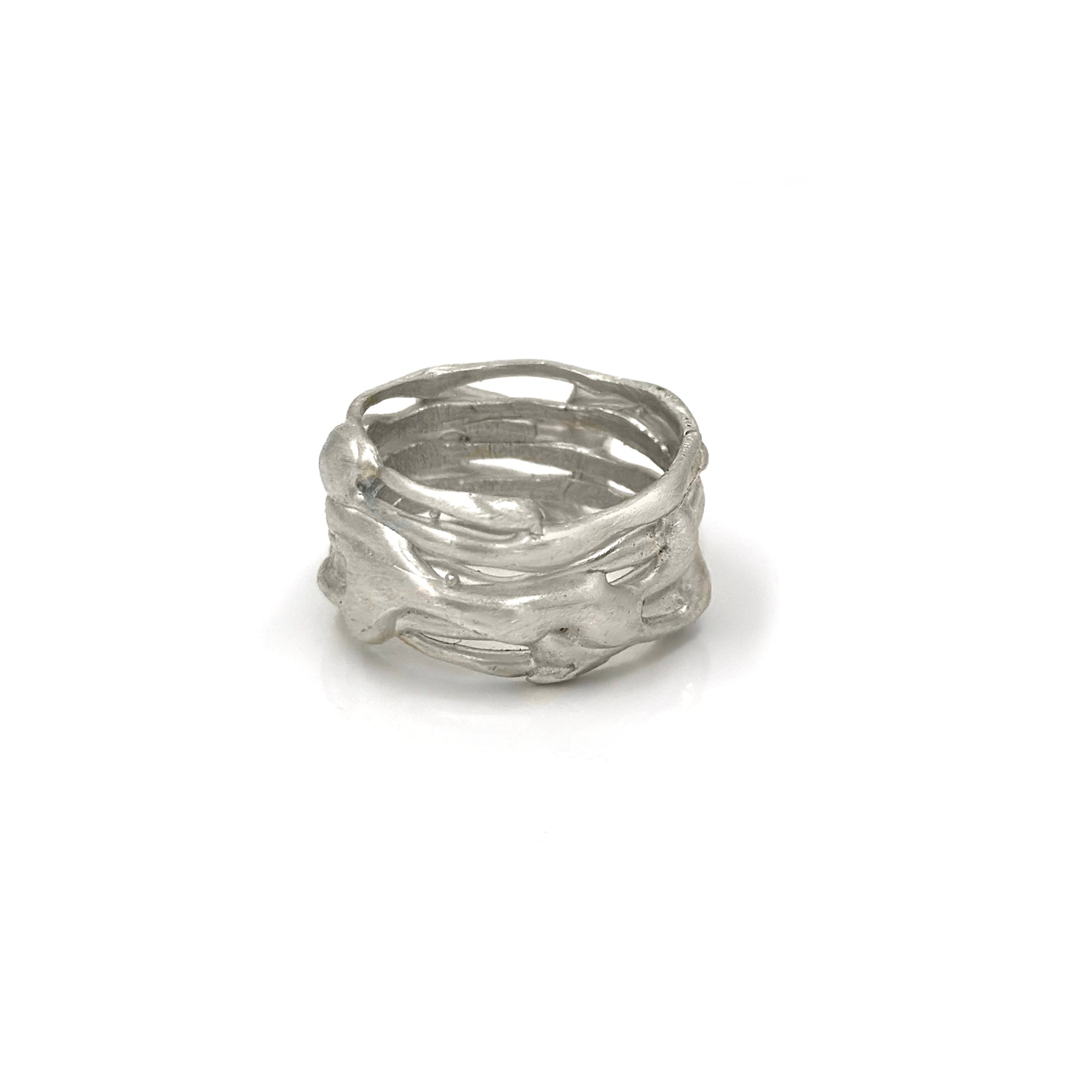 The Carousel Ring by FR | Art Jewellery features a nature-inspired textured design resembling intertwined branches, photographed on a white background. This silver ring boasts a matte finish and an organic, handcrafted appearance, perfectly capturing the essence of handmade jewellery.