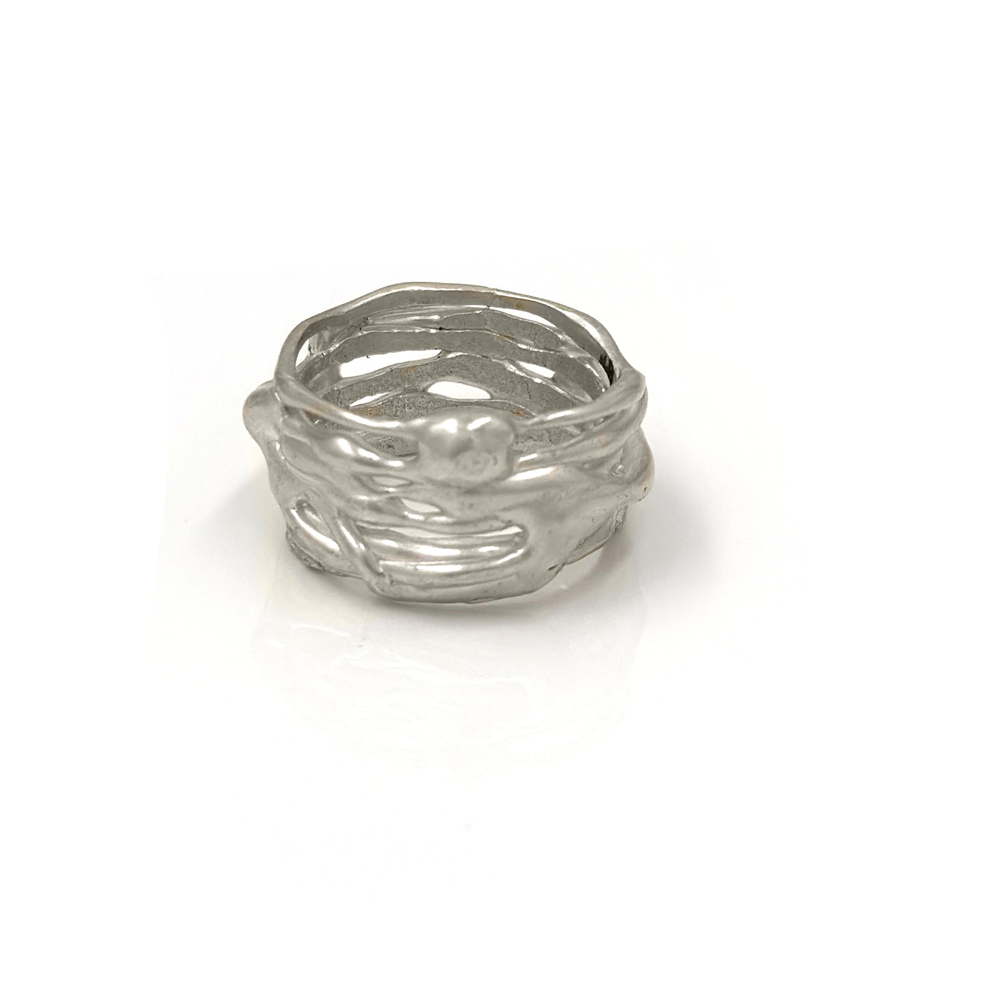 The Carousel Ring by FR | Art Jewellery features a nature-inspired textured design resembling intertwined branches, photographed on a white background. This silver ring boasts a matte finish and an organic, handcrafted appearance, perfectly capturing the essence of handmade jewellery.