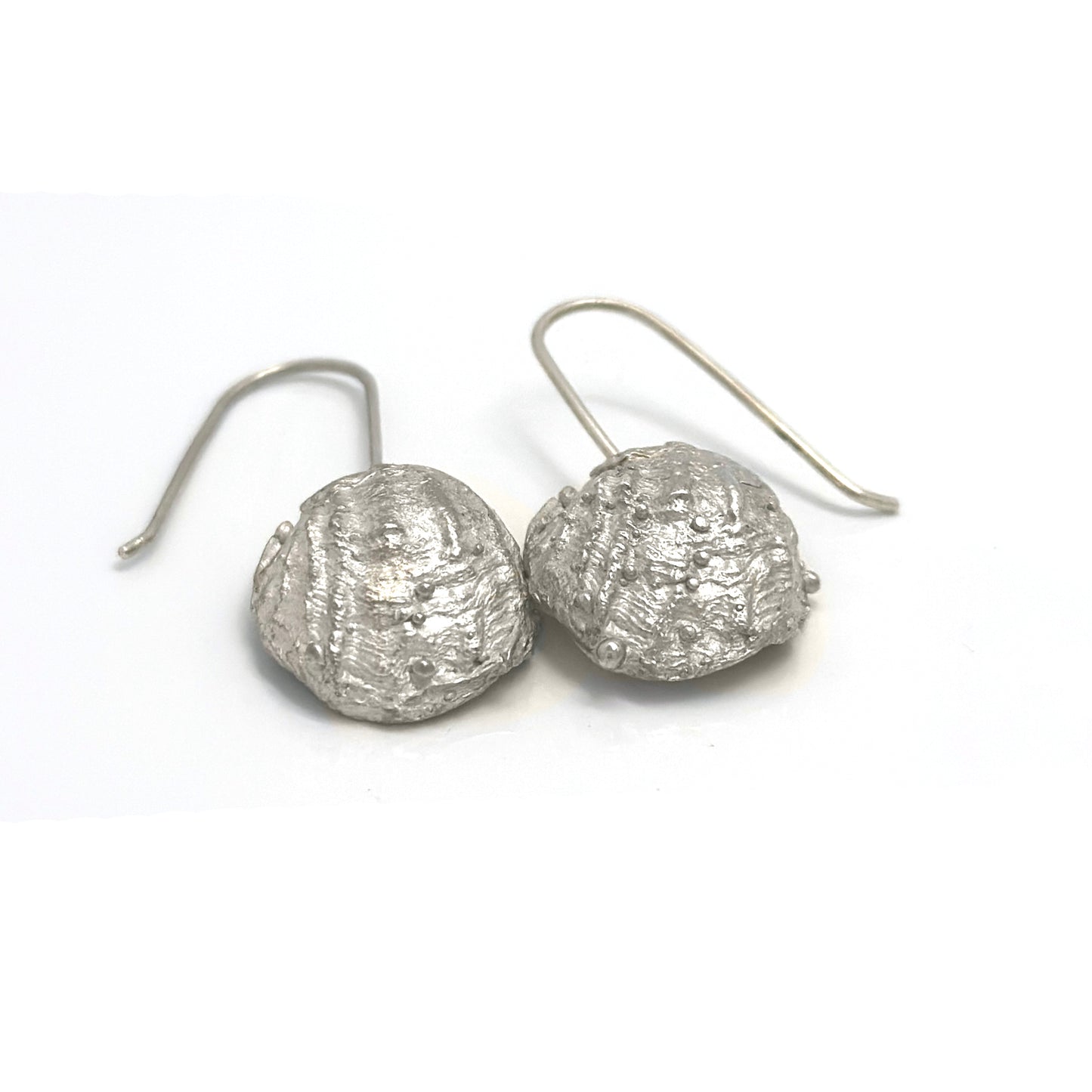 The Shelly Curve Earrings – Gold Plated in Sterling Silver by FR | Art Jewellery feature irregular, textured circular shapes and simple hook-style backings, evoking ocean-inspired designs.