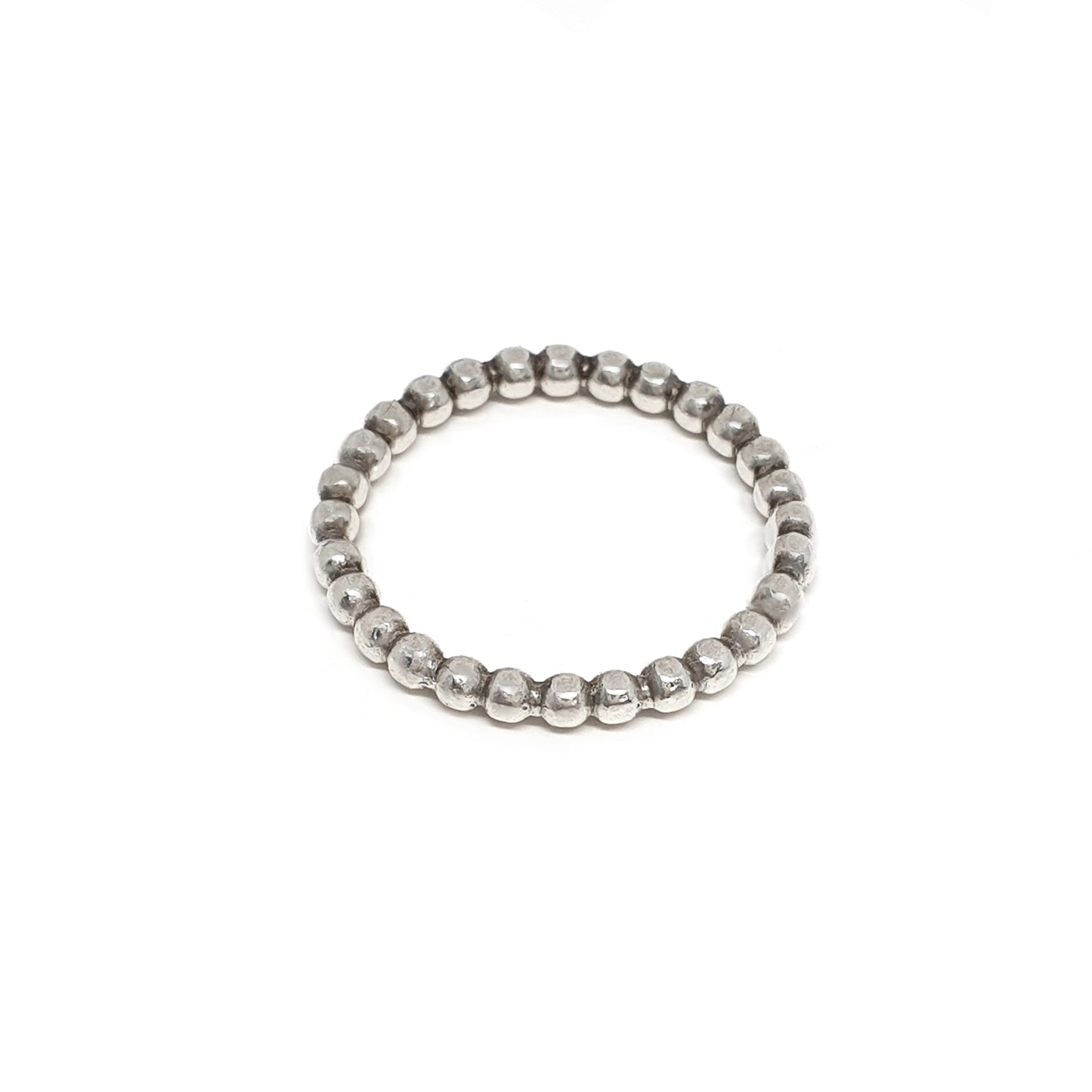 The FR | Art Jewellery Stackable Dot Ring features a single row of small, round silver beads uniformly arranged. The ring is elegantly displayed against a plain white background.