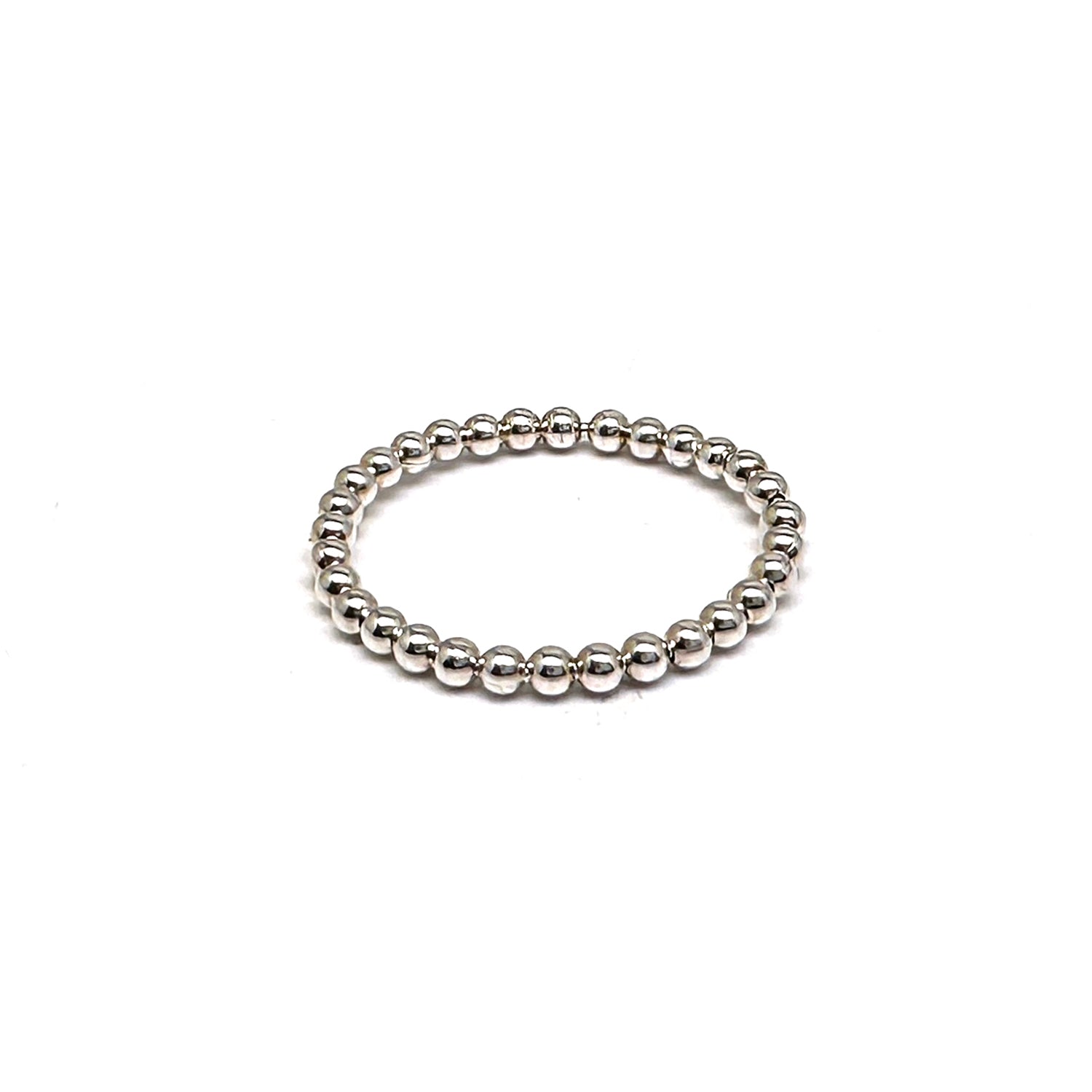 The FR | Art Jewellery Stackable Dot Ring features a single row of small, round silver beads uniformly arranged. The ring is elegantly displayed against a plain white background.