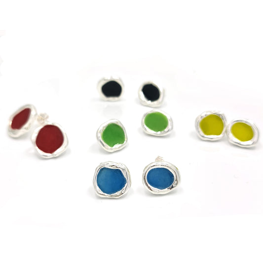 Introducing the "Drop of Colours Studs" from FR | Art Jewellery: a collection of small, round sterling silver earrings with vibrant stones. This set features pairs in an array of shades—two red, one black, one green, one yellow, and one blue—beautifully arranged on a white background.