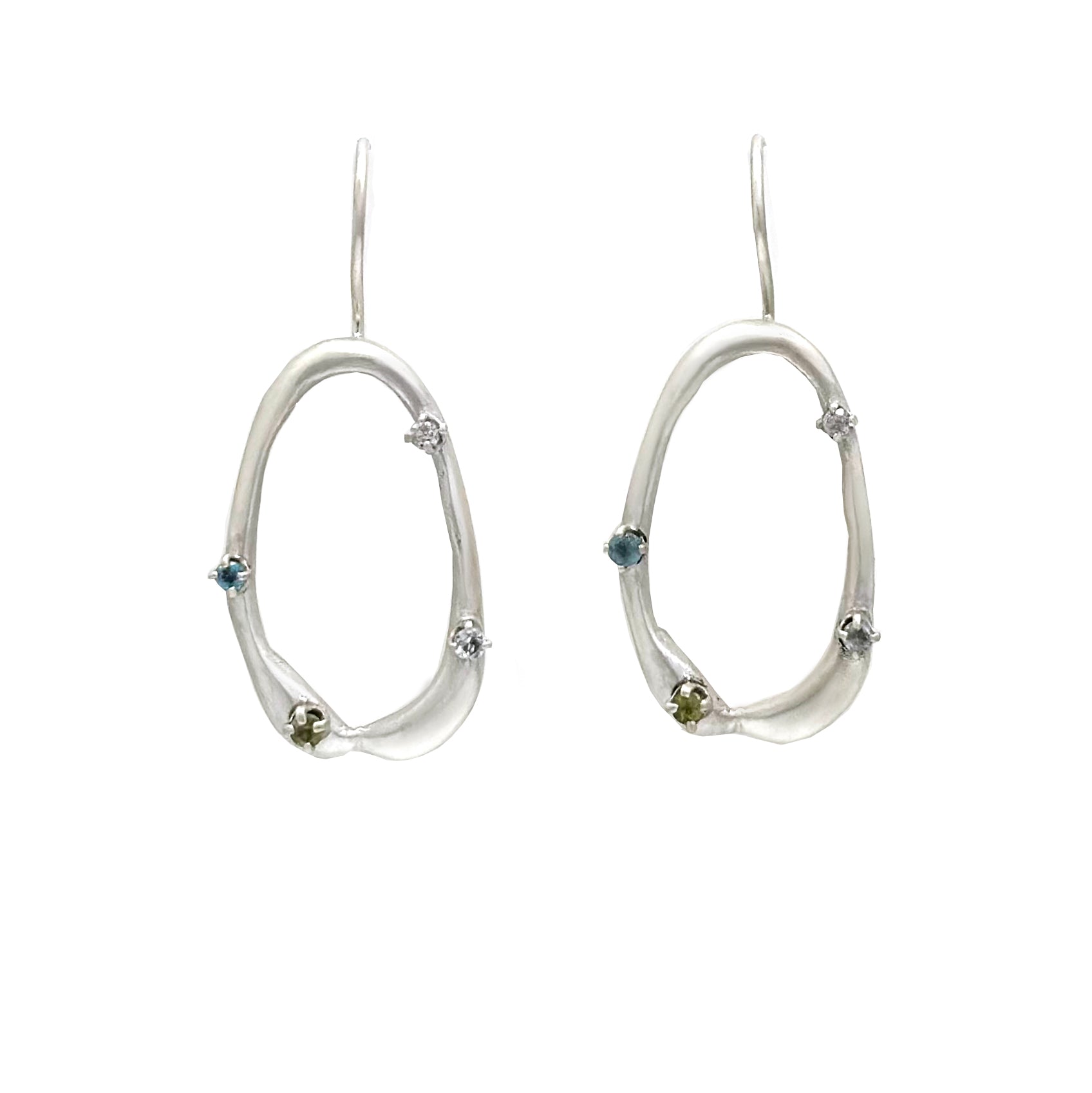 Here is the revised sentence based on the given product data:

A pair of sterling silver Drops Earrings with an irregular open hoop design, each adorned with small green gemstones and tiny star-shaped accents. Part of the Blossom series from the Inspired by Nature Collection by FR | Art Jewellery, these earrings have a hook closure and are displayed against a plain white background.