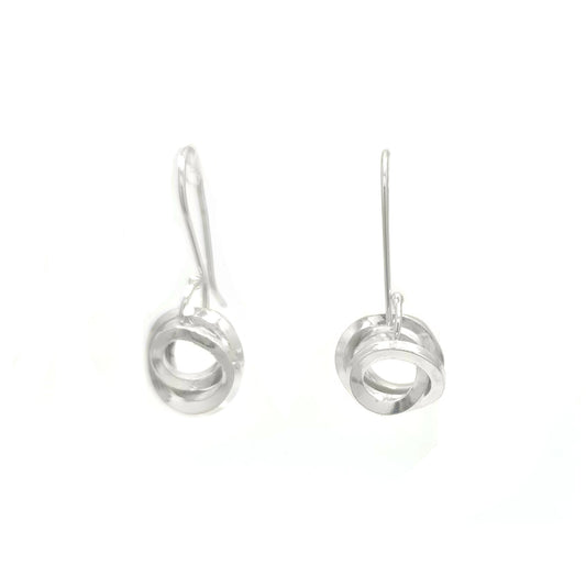 Introducing the Endless Earrings by FR | Art Jewellery – a pair of elegant silver drop earrings featuring a minimalist design with circular pendants. These handmade pieces showcase a sleek, modern look, with each pendant consisting of overlapping circular shapes. The thin, delicate hooks complement the overall simplicity perfectly. Custom-made orders are available.