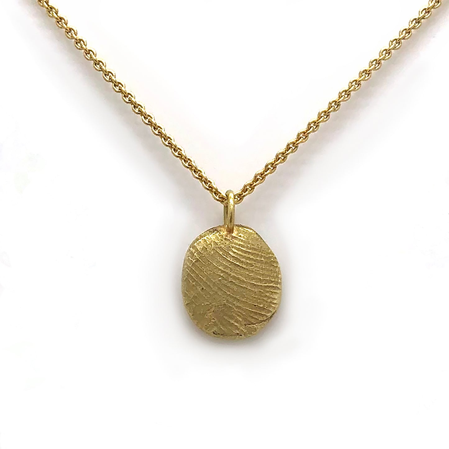 A gold fingerprint necklace with two pendants against a light background adorned with leaf patterns. The text reads, "Come and imprint your finger with me. To your loved one—note to the sender." Further personalize it with a special message or even an E-Gift Card. The logo "FR" and "FR | Art Jewellery" are also visible, along with a QR code for easy access to more details about the product: Fingerprint Voucher.