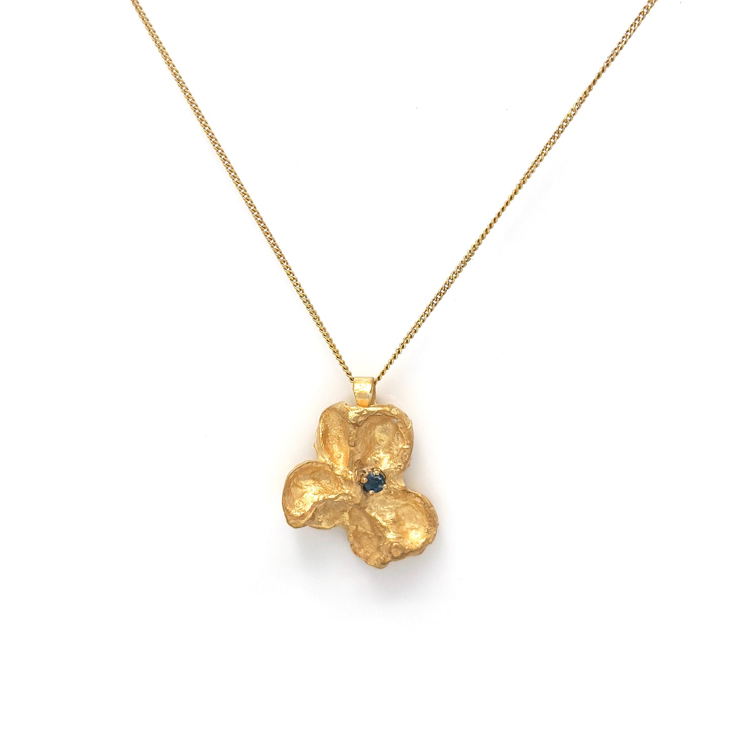 Sculptural gold-plated sterling silver pendant inspired by Australian Flindersia seed pods, set with a natural blue sapphire — handmade necklace by FR Art Jewellery.