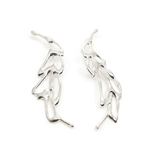 The Flow Earrings by FR | Art Jewellery are a pair of silver abstract earrings featuring an intricate, flowing design that resembles delicate intertwined branches or leaves. They appear lightweight and are artistically crafted with smooth, polished surfaces—a true testament to the elegance of handmade jewellery.