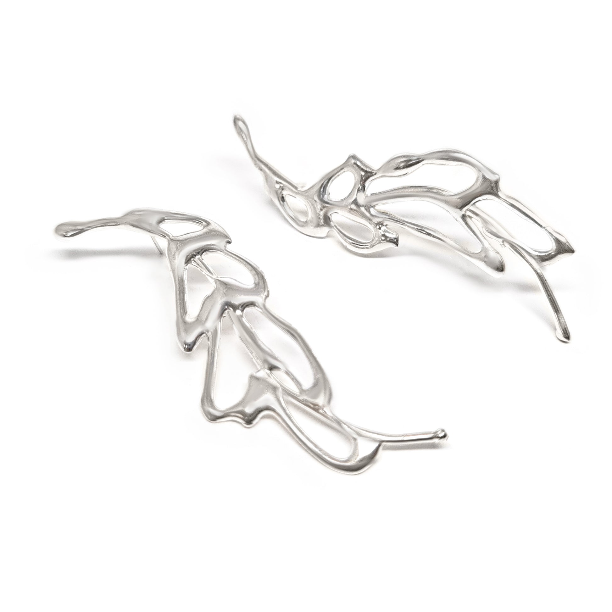 The Flow Earrings by FR | Art Jewellery are a pair of silver abstract earrings featuring an intricate, flowing design that resembles delicate intertwined branches or leaves. They appear lightweight and are artistically crafted with smooth, polished surfaces—a true testament to the elegance of handmade jewellery.