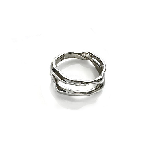 As part of the Curves Collection, the Freedom x2 Ring by FR | Art Jewellery features a sterling silver wavy design. Its intertwined bands offer a unique, modern look beautifully displayed on a reflective white surface.