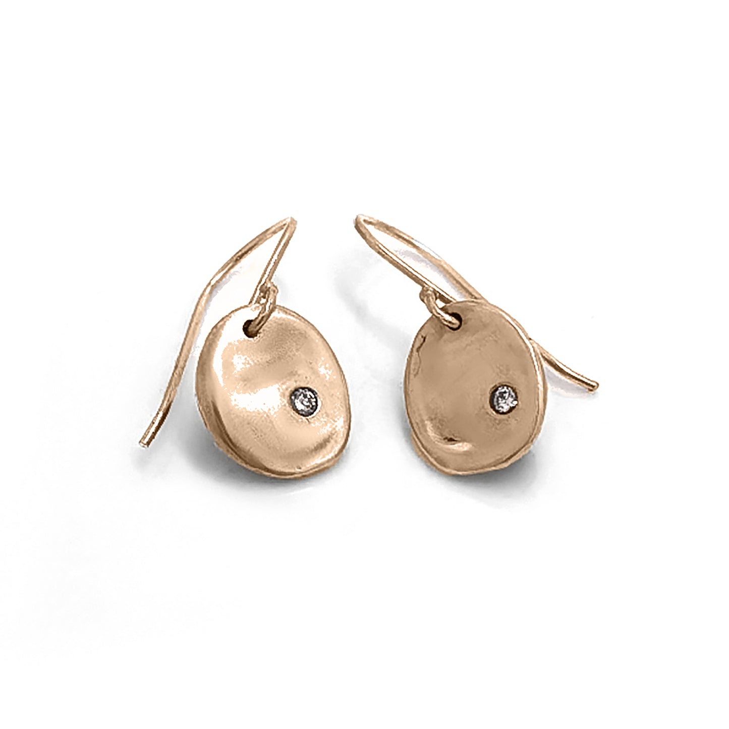 A pair of elegant Full Moon Earrings by FR | Art Jewellery, each featuring a small, round diamond set in the center. The gold discs have a slightly irregular, organic shape, giving them a unique and artisanal appearance. These handmade jewellery pieces are attached to slim hooks for wearing.