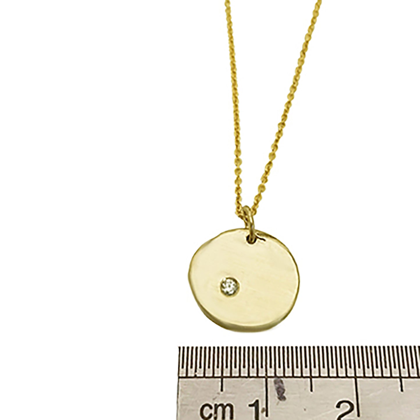 The Full Moon Necklace by FR | Art Jewellery is a delicate gold piece that features a round pendant with a small diamond embedded in the center. The thin chain perfectly complements the simple yet elegant design of the pendant, which boasts a smooth, slightly irregular surface. This necklace exemplifies the craftsmanship of handmade jewellery.