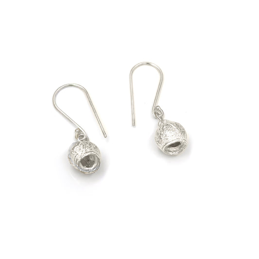 The "Gummy Earrings" by FR | Art Jewellery are a stunning pair of silver drop earrings featuring a textured hollow spherical design. The spheres are attached to hooks, allowing them to dangle freely. Simple and elegant with a minimalist yet stylish look, these handmade pieces showcase exceptional craftsmanship. Photographed against a white background, they make an exquisite addition to any jewellery collection.