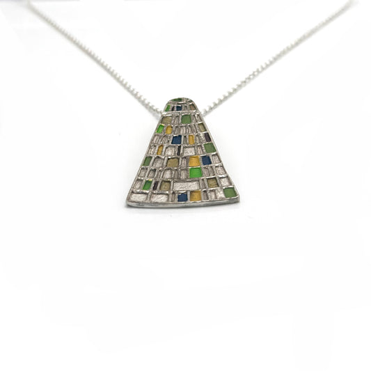 The Gustav Klimt Necklace by FR | Art Jewellery is a handmade sterling silver piece featuring a triangular pendant with a mosaic of green, yellow, blue, and silver tiles, inspired by Klimt. Shown on a white background.