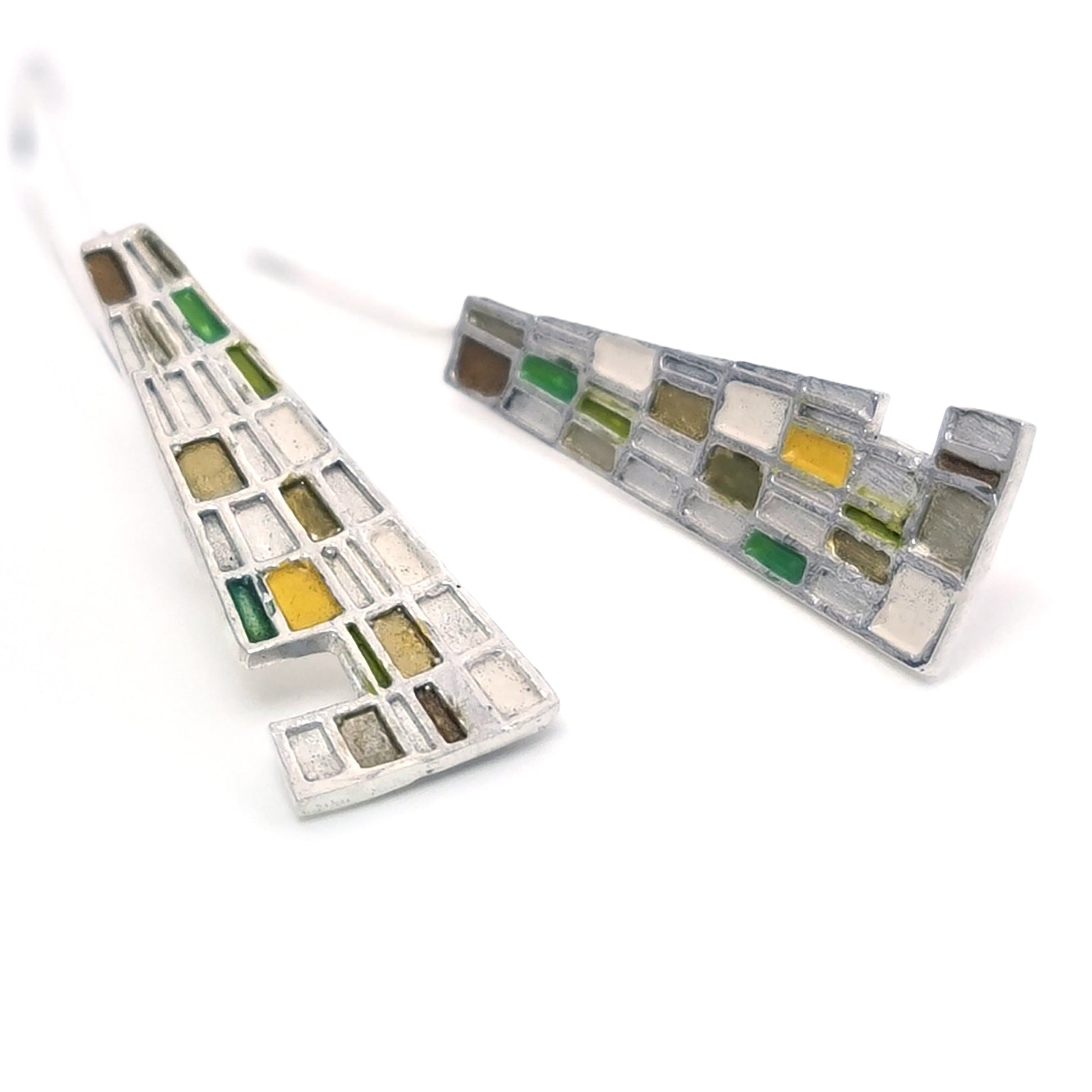 Introducing the Gustav Small Earrings by FR | Art Jewellery: A pair of handmade, dangling earrings showcasing a mosaic design with tiny squares and rectangles in a vibrant array of blue, green, purple, and beige. These silver-set earrings offer a geometric and modern aesthetic, making them perfect for custom-made orders.