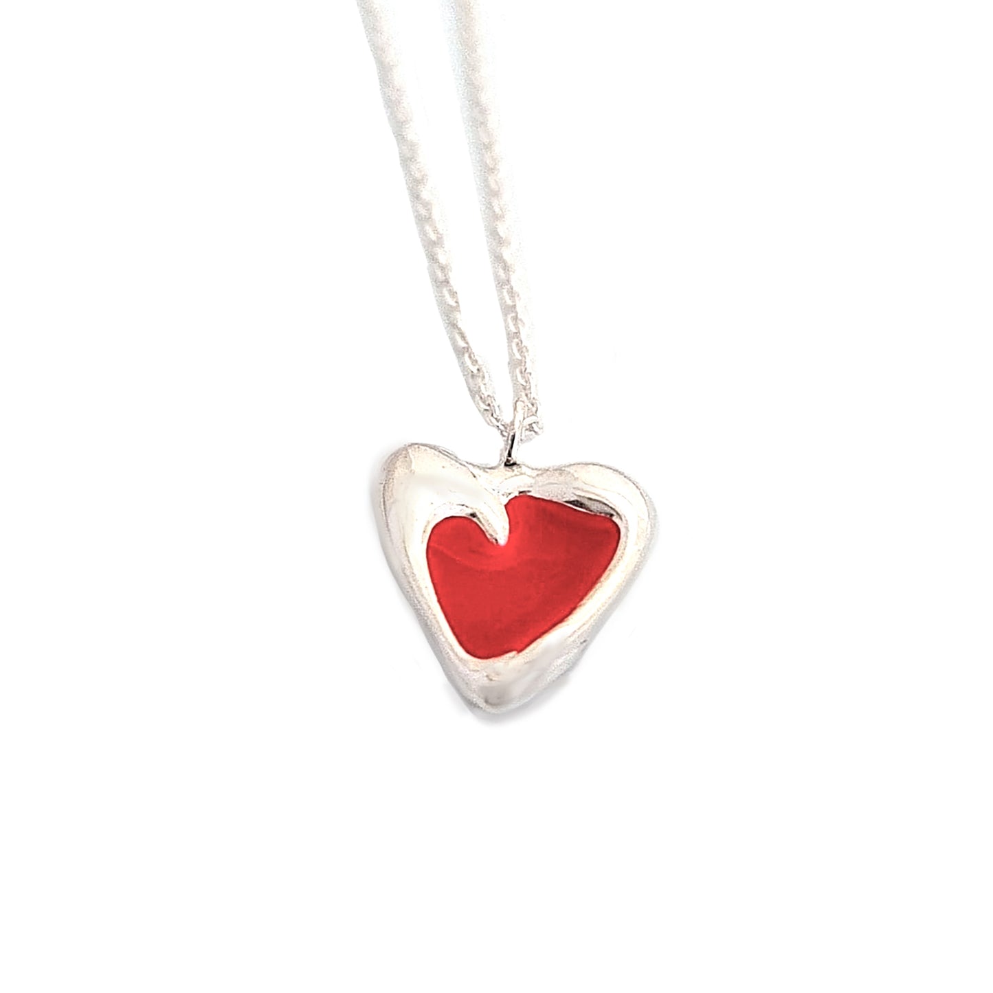 Introducing the Heart Colours necklace by FR | Art Jewellery, a stunning silver accessory featuring a heart-shaped pendant with a vibrant red interior and a delicate white border. This elegant piece is gracefully suspended from a fine silver chain. As part of our handmade jewellery collection, it exemplifies exquisite craftsmanship against a plain white background.