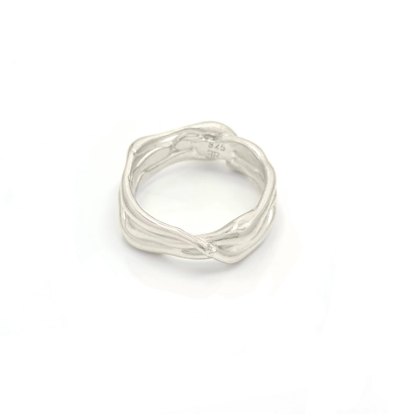 The Freedom Infinite Ring by FR | Art Jewellery is a sterling silver masterpiece designed to resemble intertwined branches, showcasing unique craftsmanship for a natural and organic look.