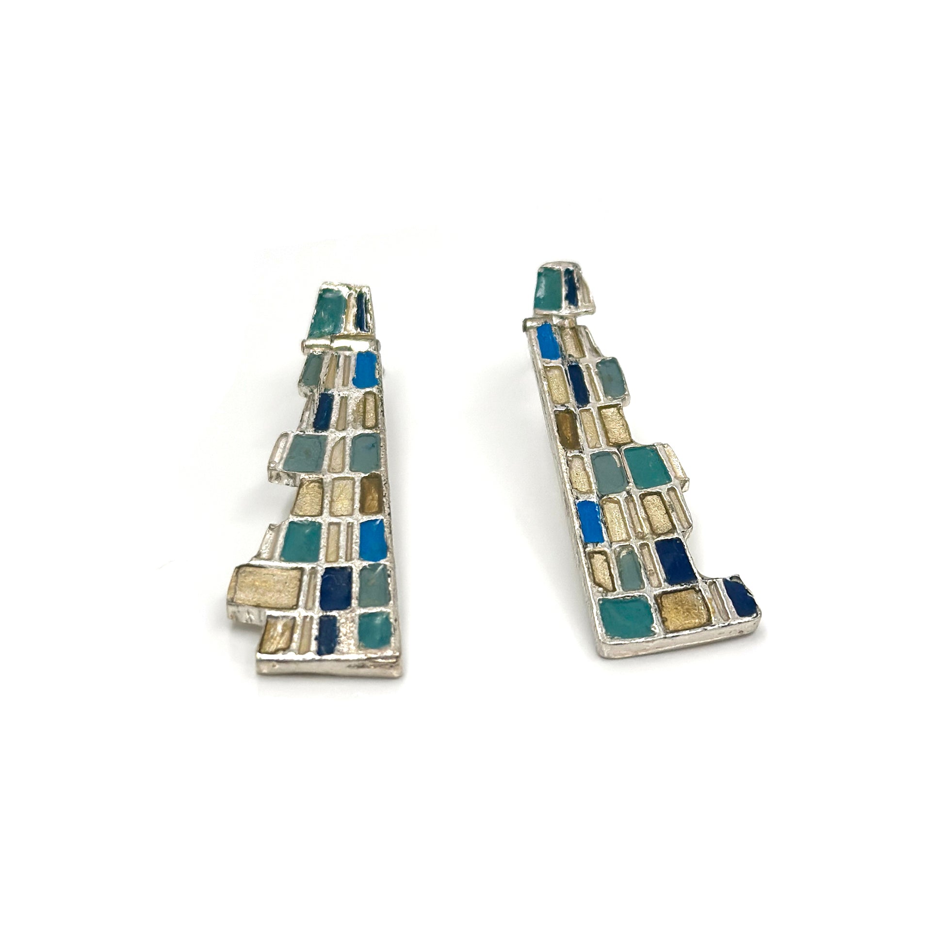 The Klimt Earrings by FR | Art Jewellery feature geometric building-inspired shapes in enamel-painted sterling silver, with blue, turquoise, gold, and white inlays. Displayed on a white background.