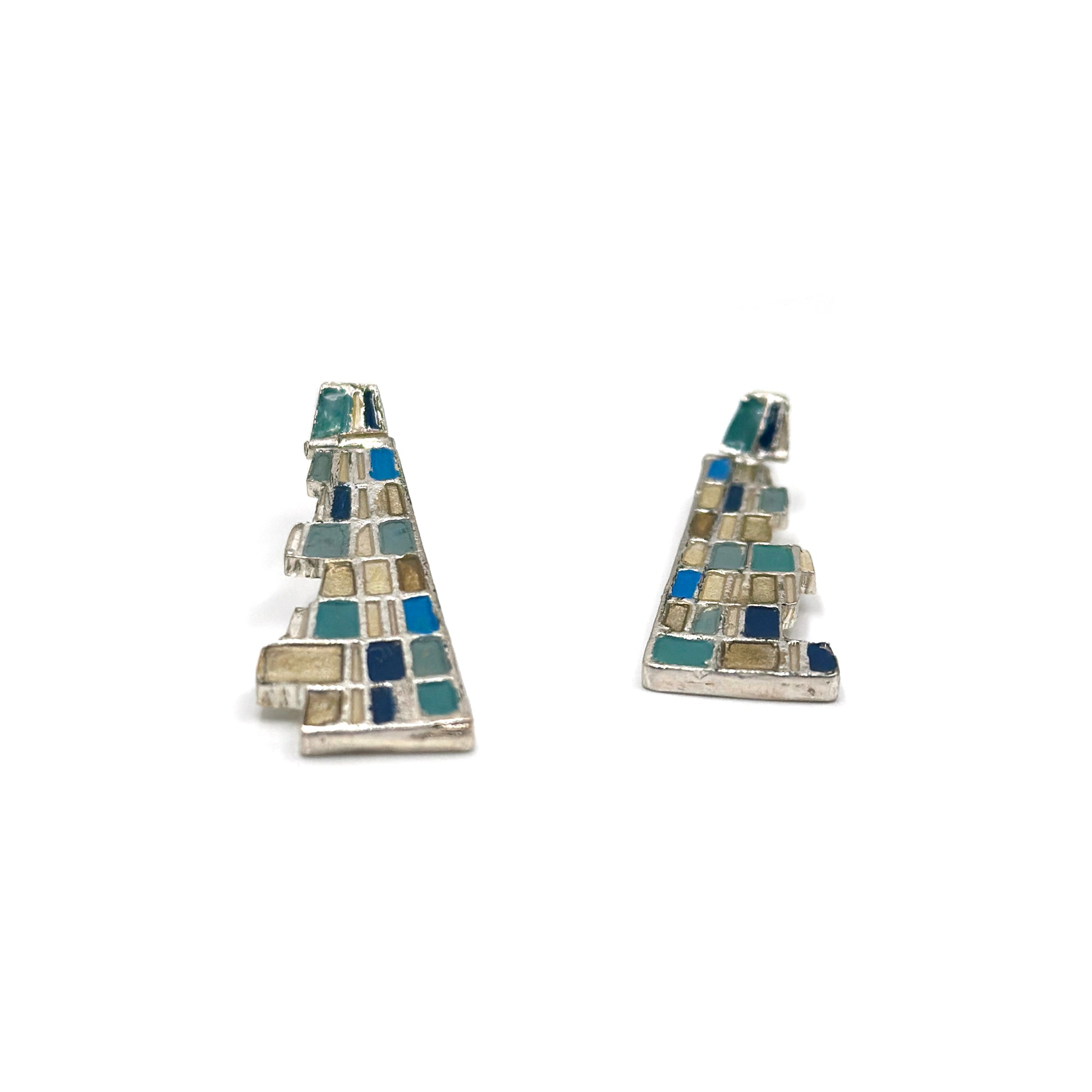 The Klimt Earrings by FR | Art Jewellery feature geometric building-inspired shapes in enamel-painted sterling silver, with blue, turquoise, gold, and white inlays. Displayed on a white background.
