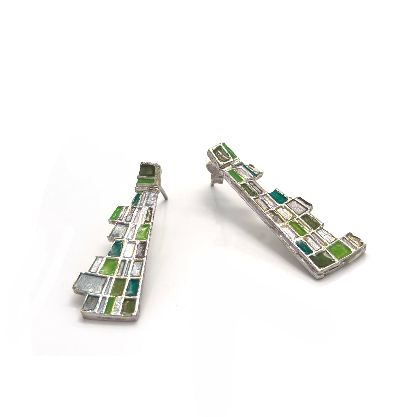The Klimt Earrings by FR | Art Jewellery feature geometric building-inspired shapes in enamel-painted sterling silver, with blue, turquoise, gold, and white inlays. Displayed on a white background.